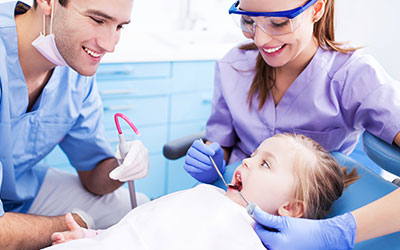 Dentist and Assistant working on patient